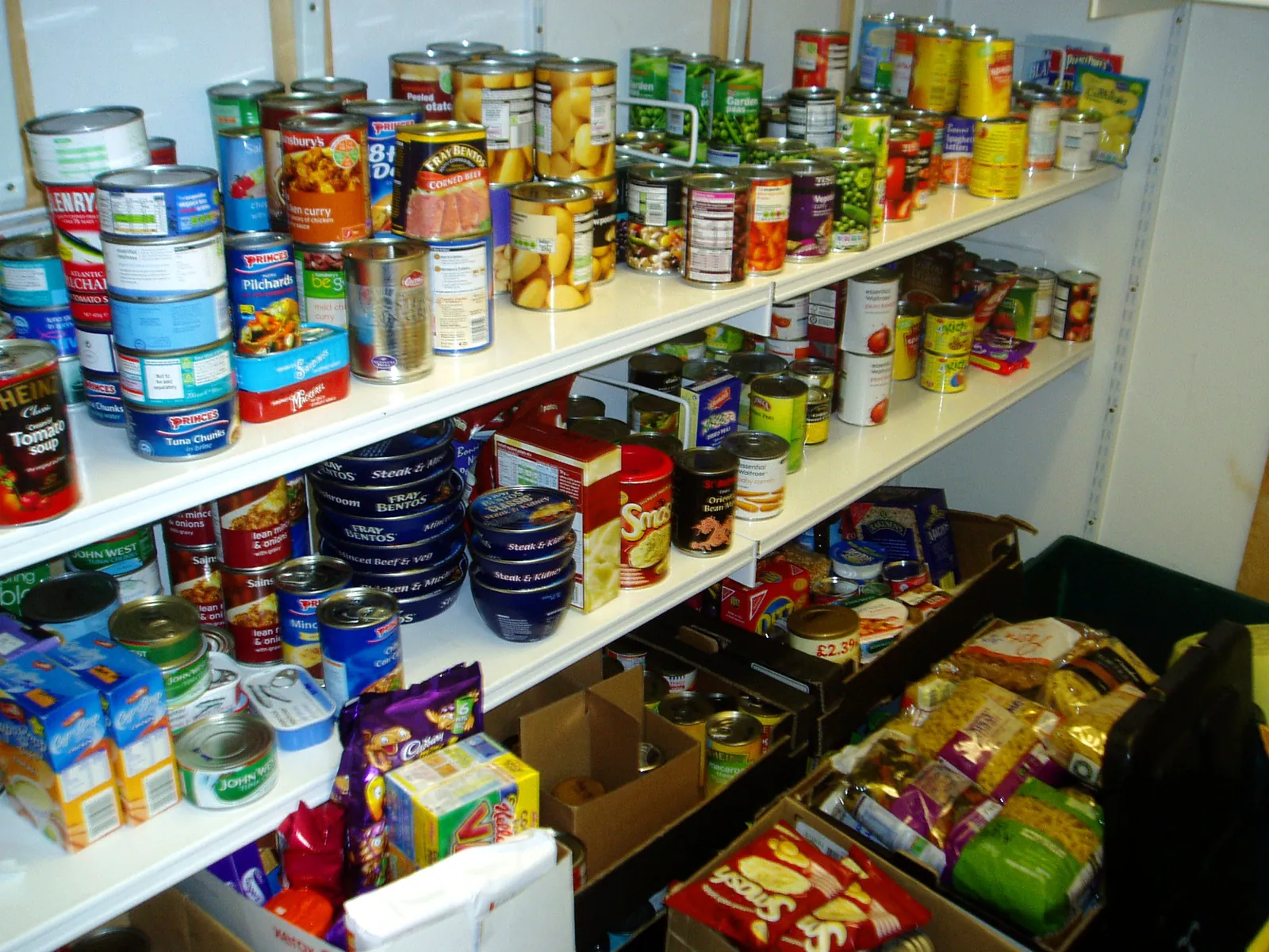 Shelves in the Food Bank store stacked with tins, packets and jars